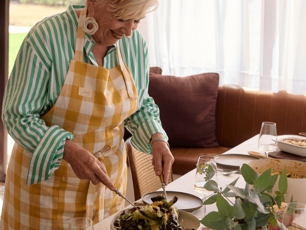 Maggie Beer wearing a gingham apron